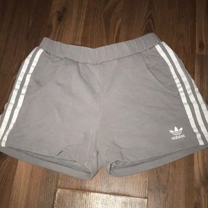 Grey Adidas shorts with white stripes
